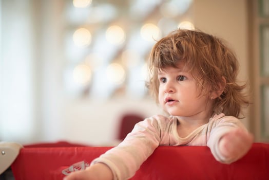 little baby girl with strange hairstyle and curlers photo
