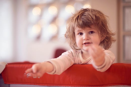 little baby girl with strange hairstyle and curlers photo