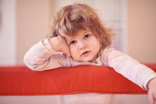 little baby girl with strange hairstyle and curlers photo