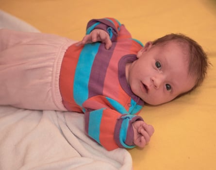 One month newborn baby sleeping  in bed photo