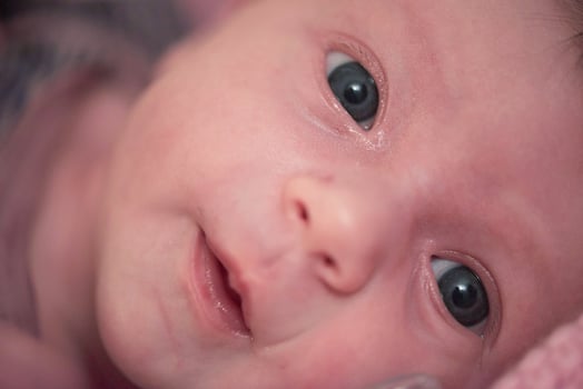 One month newborn baby sleeping  in bed photo