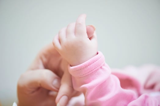 mother is playing with baby at home photo