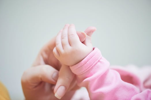 mother is playing with baby at home photo