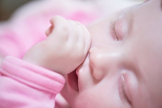 newborn baby sleeping  at home in bed photo