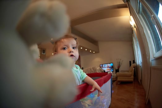 cute  little  baby playing in mobile  bed photo