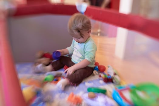 cute  little  baby playing in mobile  bed photo
