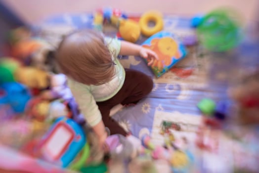 cute  little  baby playing in mobile  bed photo