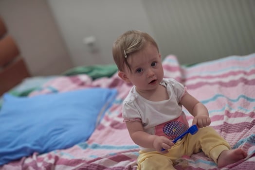cute  little one year old baby and making first steps in bed photo