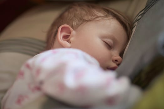 newborn baby sleeping  at home in bed photo