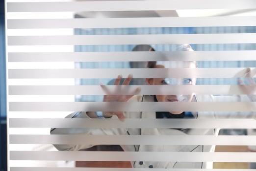 young businesswoman looking trought transparent wall photo