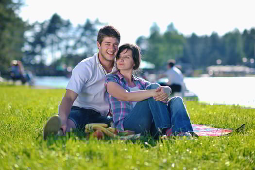 happy young couple having a picnic outdoor photo