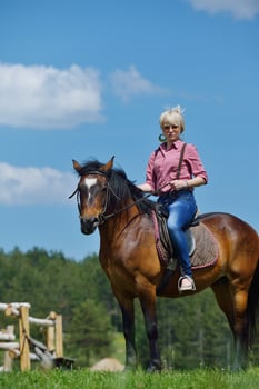 happy woman  on  horse photo