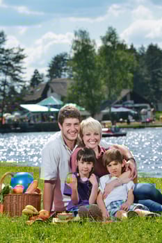 Happy family playing together in a picnic outdoors photo