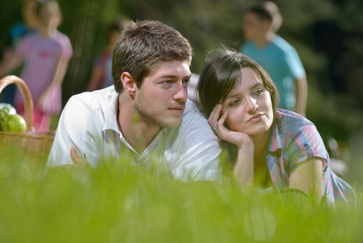 happy young couple having a picnic outdoor photo
