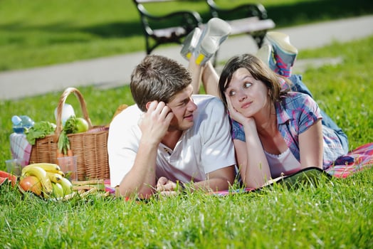 happy young couple having a picnic outdoor photo