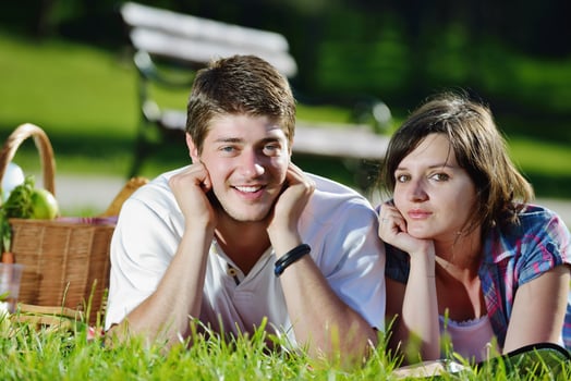 happy young couple having a picnic outdoor photo