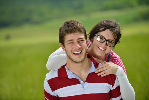 Portrait of romantic young couple smiling together outdoor photo