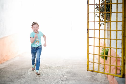 little girl running on the city streets photo