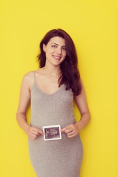 pregnant woman showing ultrasound picture photo