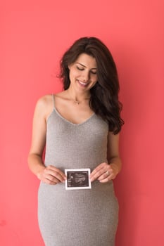 happy pregnant woman showing ultrasound picture photo