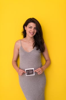 pregnant woman showing ultrasound picture photo