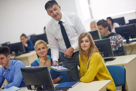 students with teacher  in computer lab classrom photo