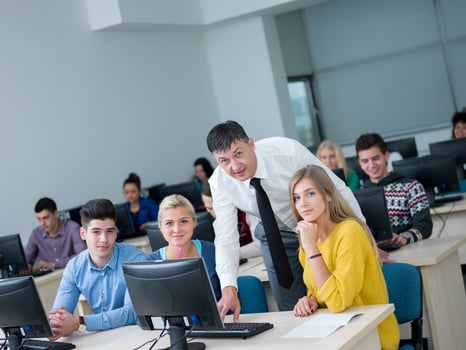 students with teacher  in computer lab classrom photo