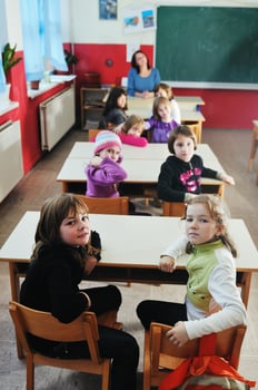 happy teacher in  school classroom photo