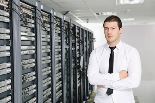 young it engeneer in datacenter server room photo