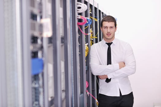 young it engeneer in datacenter server room photo