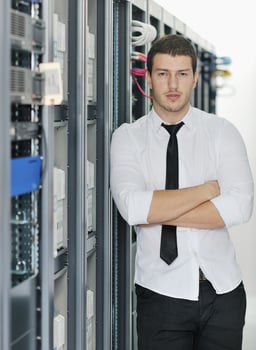 young it engeneer in datacenter server room photo