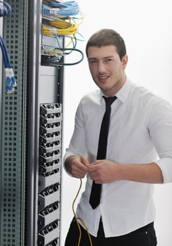 young it engeneer in datacenter server room photo