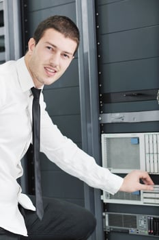 young it engeneer in datacenter server room photo