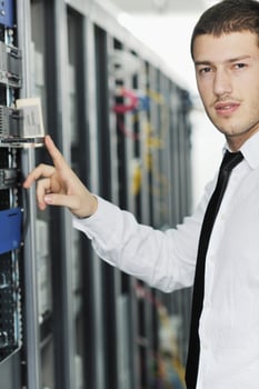 young it engeneer in datacenter server room photo