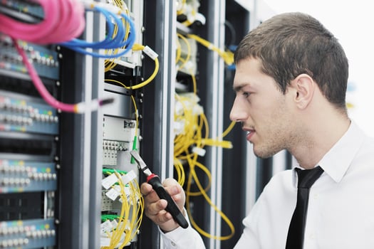 young it engeneer in datacenter server room photo