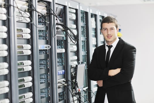 young it engeneer in datacenter server room photo
