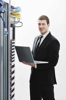 businessman with laptop in network server room photo