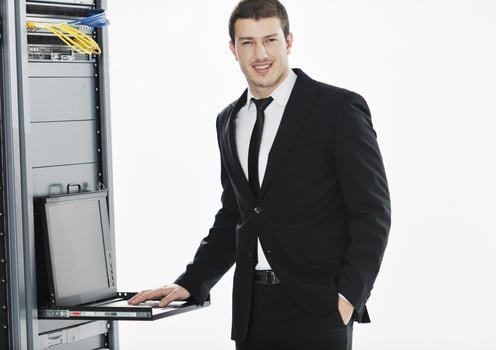 businessman with laptop in network server room photo