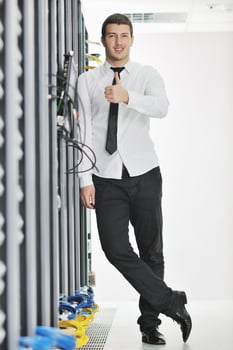young engeneer in datacenter server room photo