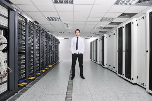 young engeneer in datacenter server room photo
