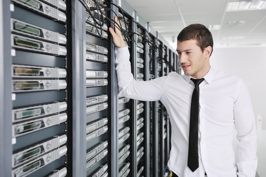 young engeneer in datacenter server room photo