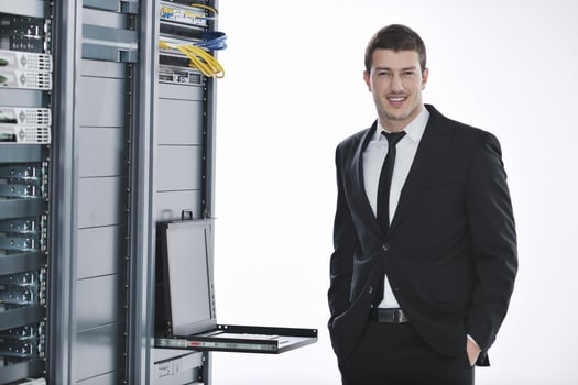 young engeneer in datacenter server room photo