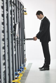 young engeneer in datacenter server room photo