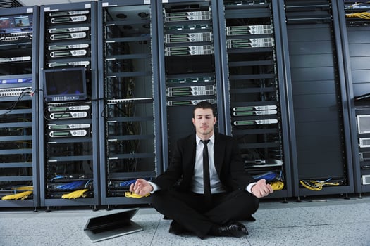 business man practice yoga at network server room photo