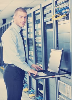 young it engeneer in datacenter server room photo