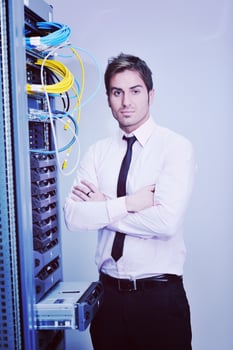young it engineer in datacenter server room photo