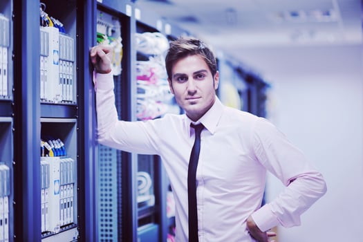 young it engeneer in datacenter server room photo