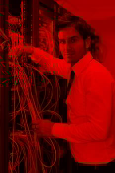 young it engineer in datacenter server room photo