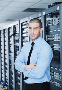young it engineer in datacenter server room photo