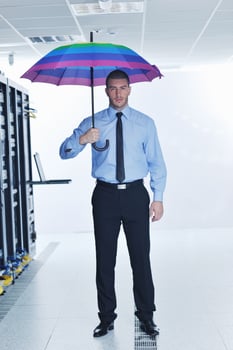 businessman hold umbrella in server room photo